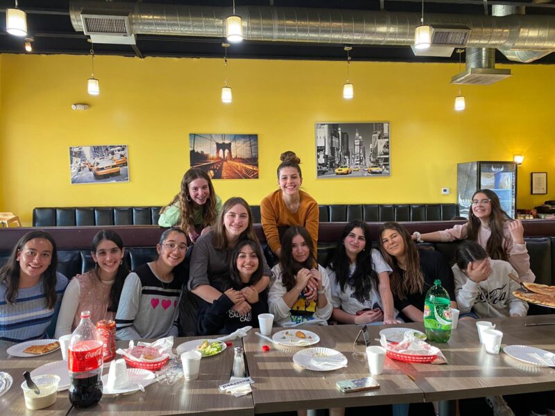 Alta Shaina Welner (center) with friends at a kosher pizza shop in Phoenix