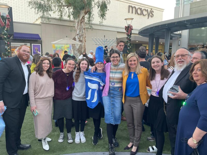 Alta Shaina Welner (center) at a Chanukah event with Arizona Head Shluchim Rabbi Zalman and Tzipi Levertov and Phoenix Mayor Kate Gallego