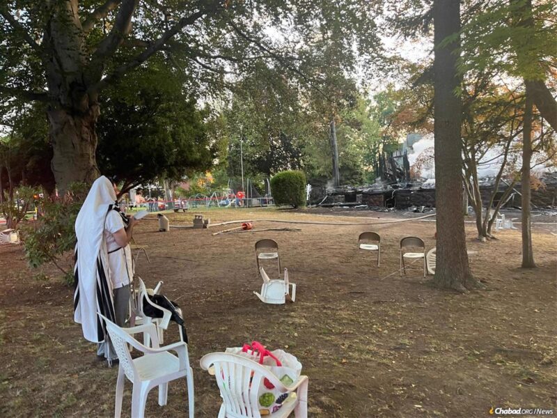 Rabbi Yitzchok Lerman davens near the ruins of Congregation Beth El in East Rutherford, N.J.