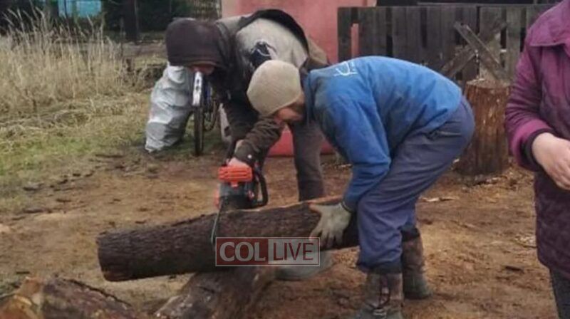 One way for this Jewish family in Vinnytsia to stay warm is to chop logs for heat
