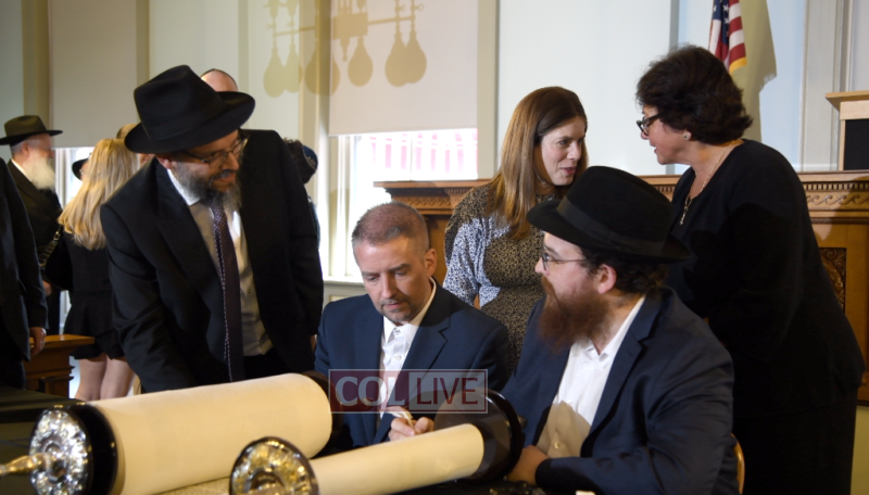 Rabbi Schneur Oirechman, Chief of Staff Alex Kelly, Rabbi Yisroel Chanowitz. In the back are Chanie Oirechman and Senate President Kathleen Passidomo<br />
