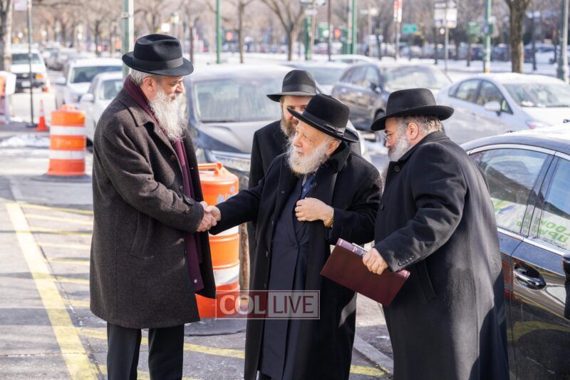 Rabbi Nosson Blumes, Director of Development of Oholei Torah, greets Rabbi Yitzchok Raitport and his children